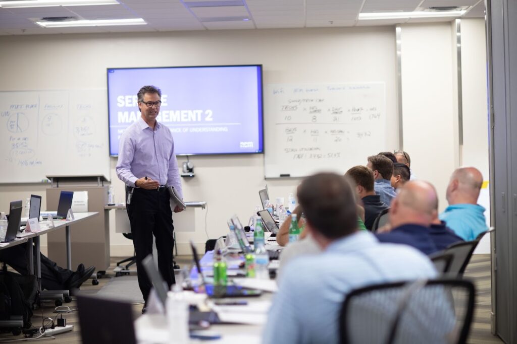 a man is giving a presentation in a classroom
