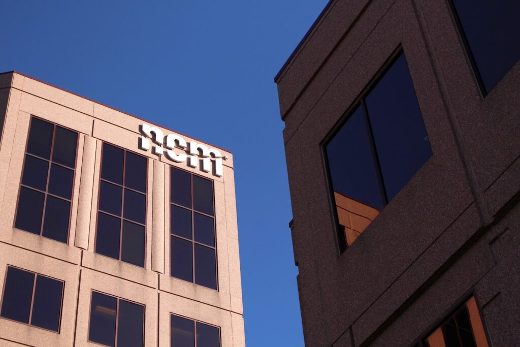 a view of the NCM logo on the outside of the office building