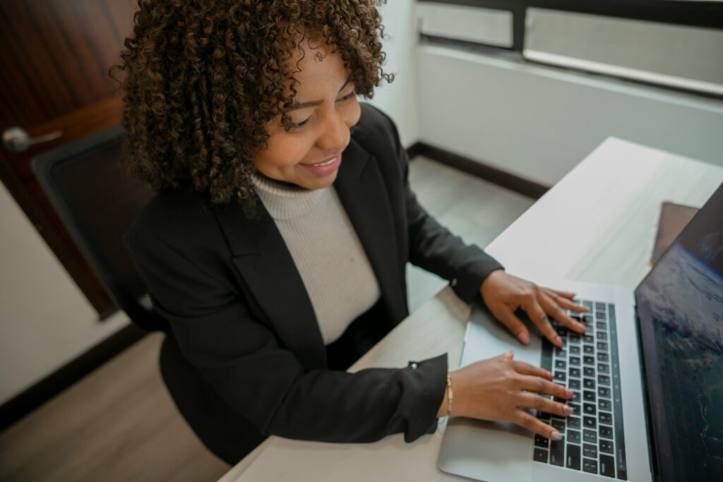 a birds eye view and close up of a woman working on a laptop