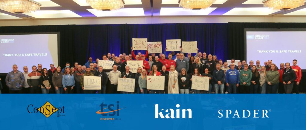 a picture of the whole NCM team at the 2024 Intelligence Summit, some of them are holding handmade posters that say Thank You