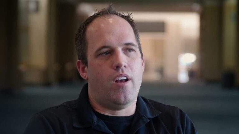 a photo of Kevin Zoodsma, a man with brown hair and black shirt, the background is completely blurred
