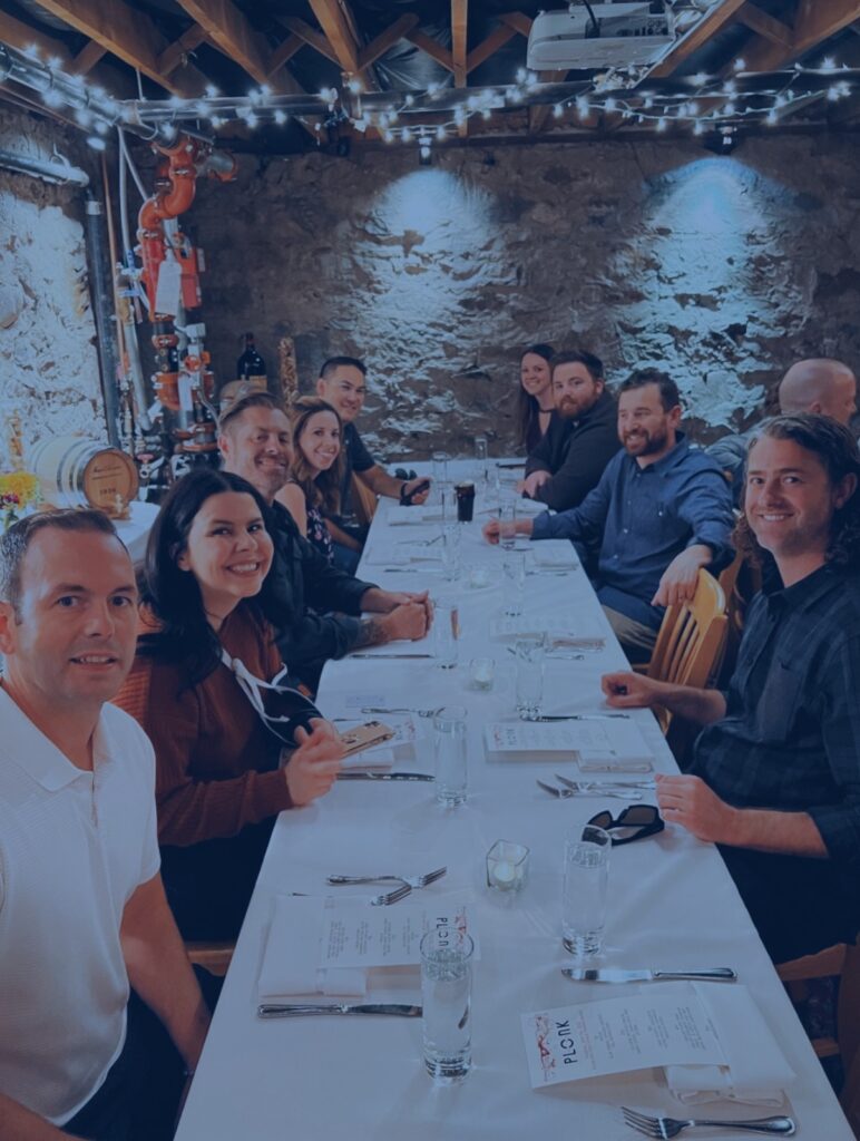 a group of people gathered for a dinner at a long table