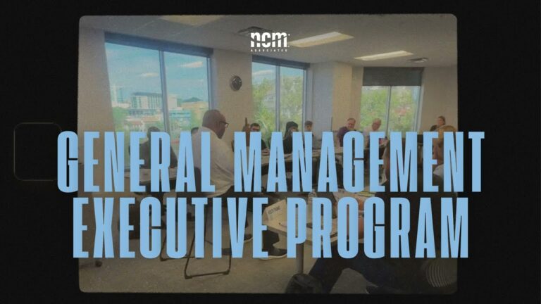 the text General Management Executive Program imposed over an image of a group of people sitting around a table in a conference room. The text takes up most of the photo.